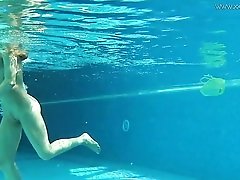 Underwater solo teen swims in the nude