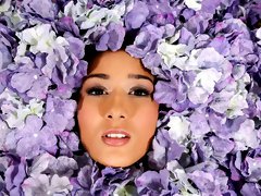 Among the petals lies beauty untold until now, as the lovely Darcia Lee lies on a bed covered in flowers, her mouth open to accept Joohn Syx's ha