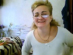 Naughty mature woman with glasses flashes her big tits on t